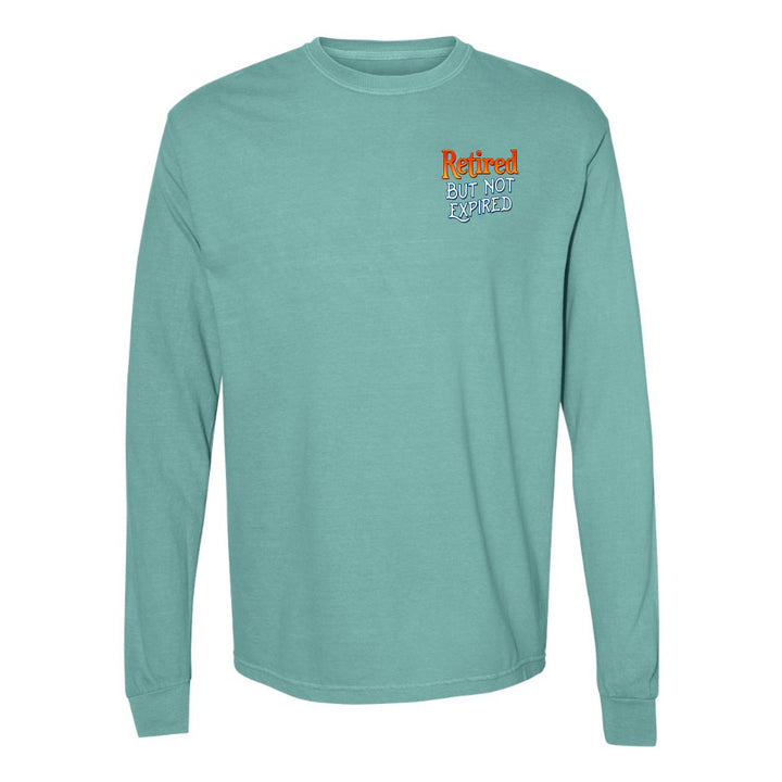 Teal long-sleeve shirt with 'Retired but not expired' text on a white background