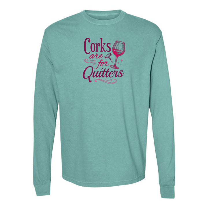 Teal long-sleeve shirt with pink text and wine glass graphic on a white background