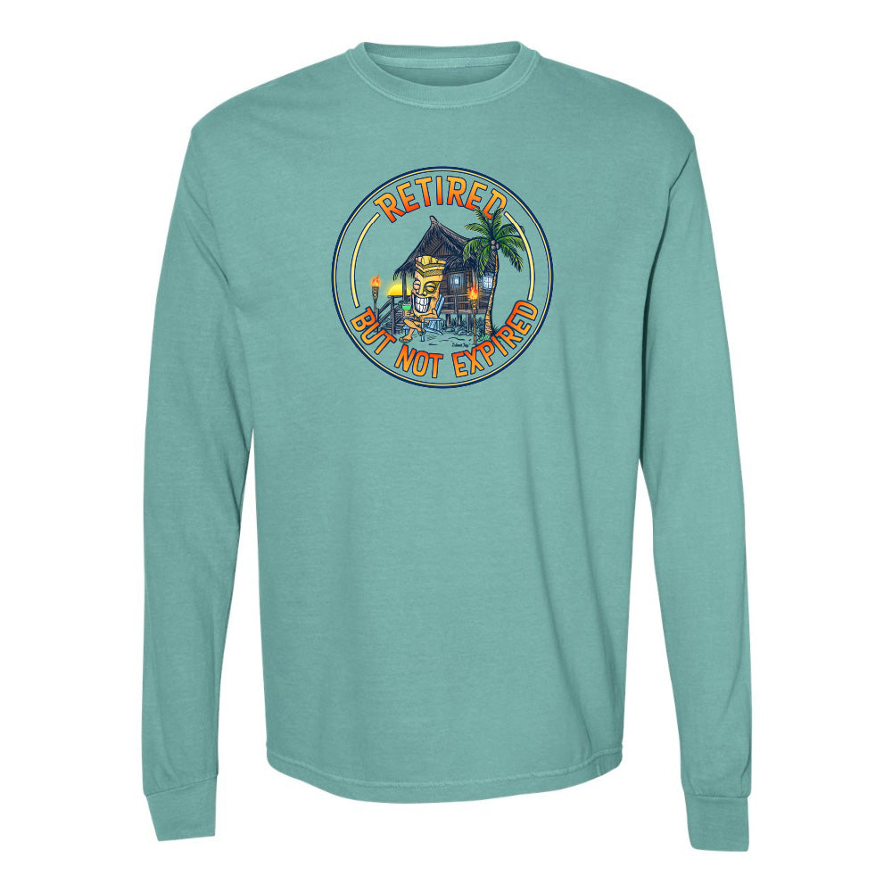 Teal long-sleeve shirt with a tropical graphic and 'Retired But Not Expired' text on a white background