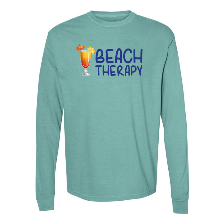 Teal long-sleeve shirt with 'Beach Therapy' text and cocktail graphic on a white background