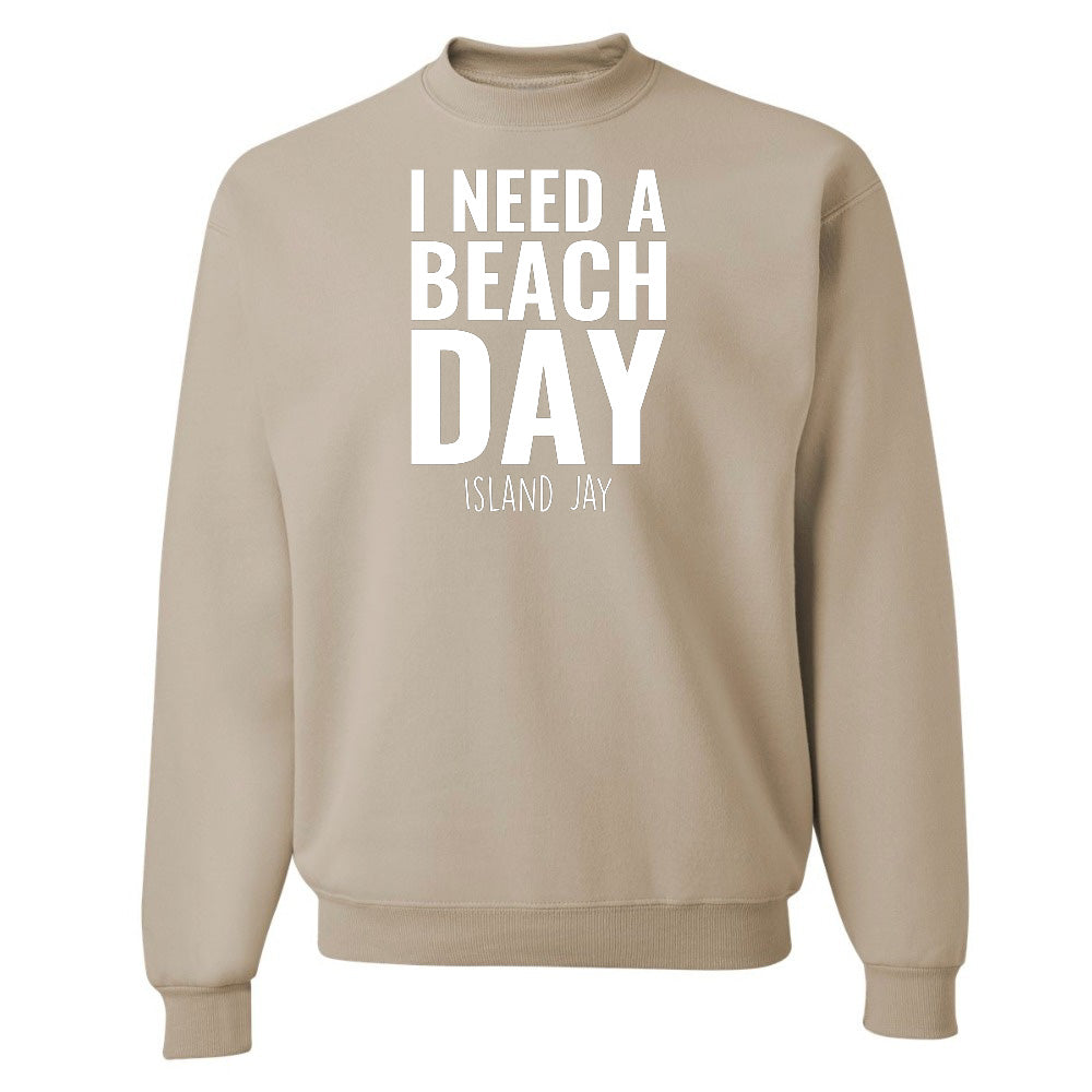 Beige sweatshirt with 'I NEED A BEACH DAY' text on a white background