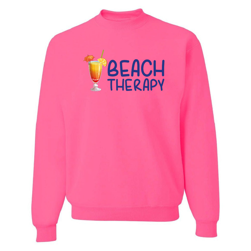Pink sweatshirt with 'Beach Therapy' text and cocktail graphic on a white background