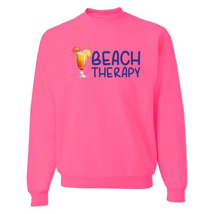 Pink sweatshirt with 'Beach Therapy' text and cocktail graphic on a white background
