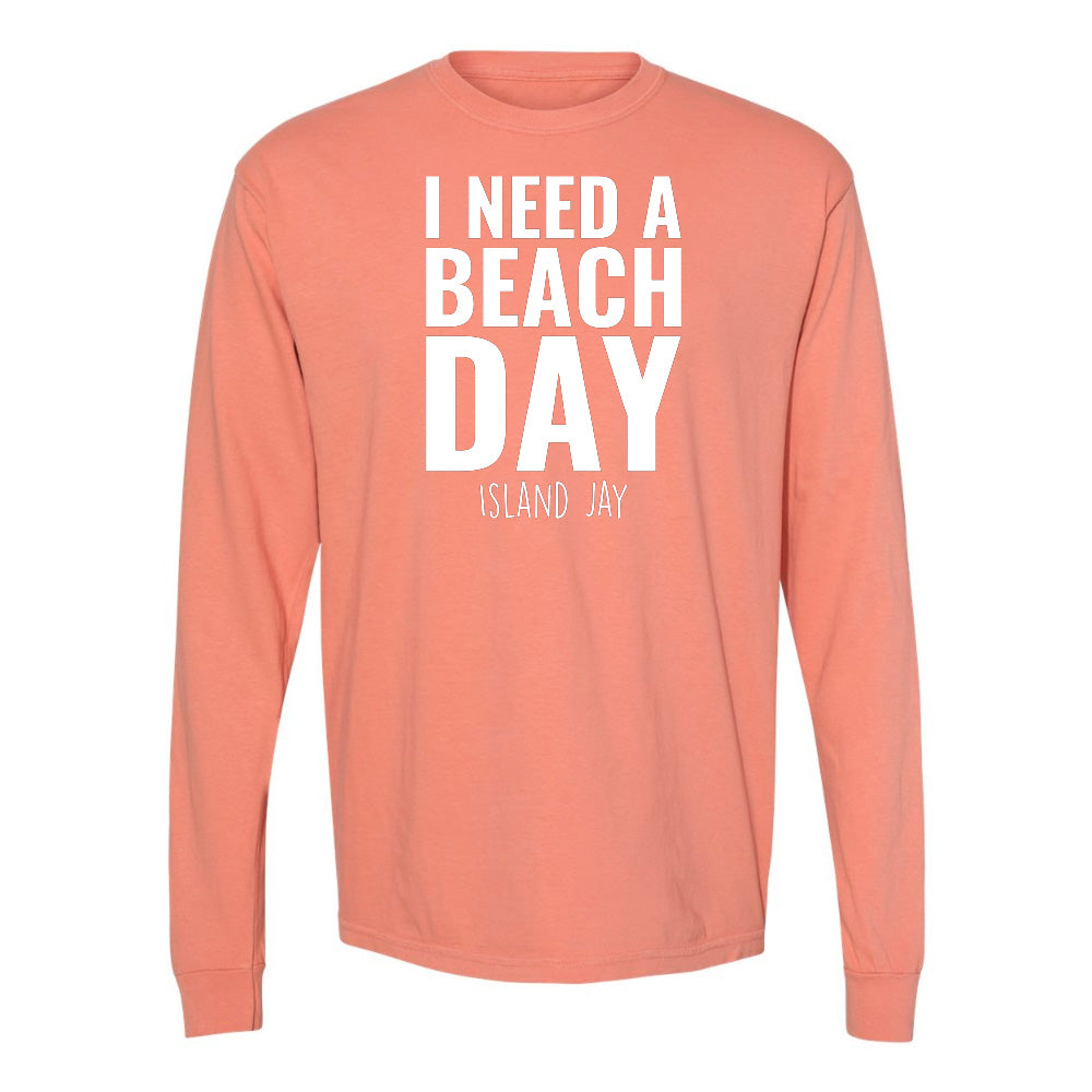 Coral long-sleeve shirt with 'I Need a Beach Day' text on a white background