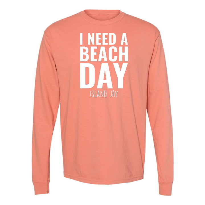 Coral long-sleeve shirt with 'I Need a Beach Day' text on a white background