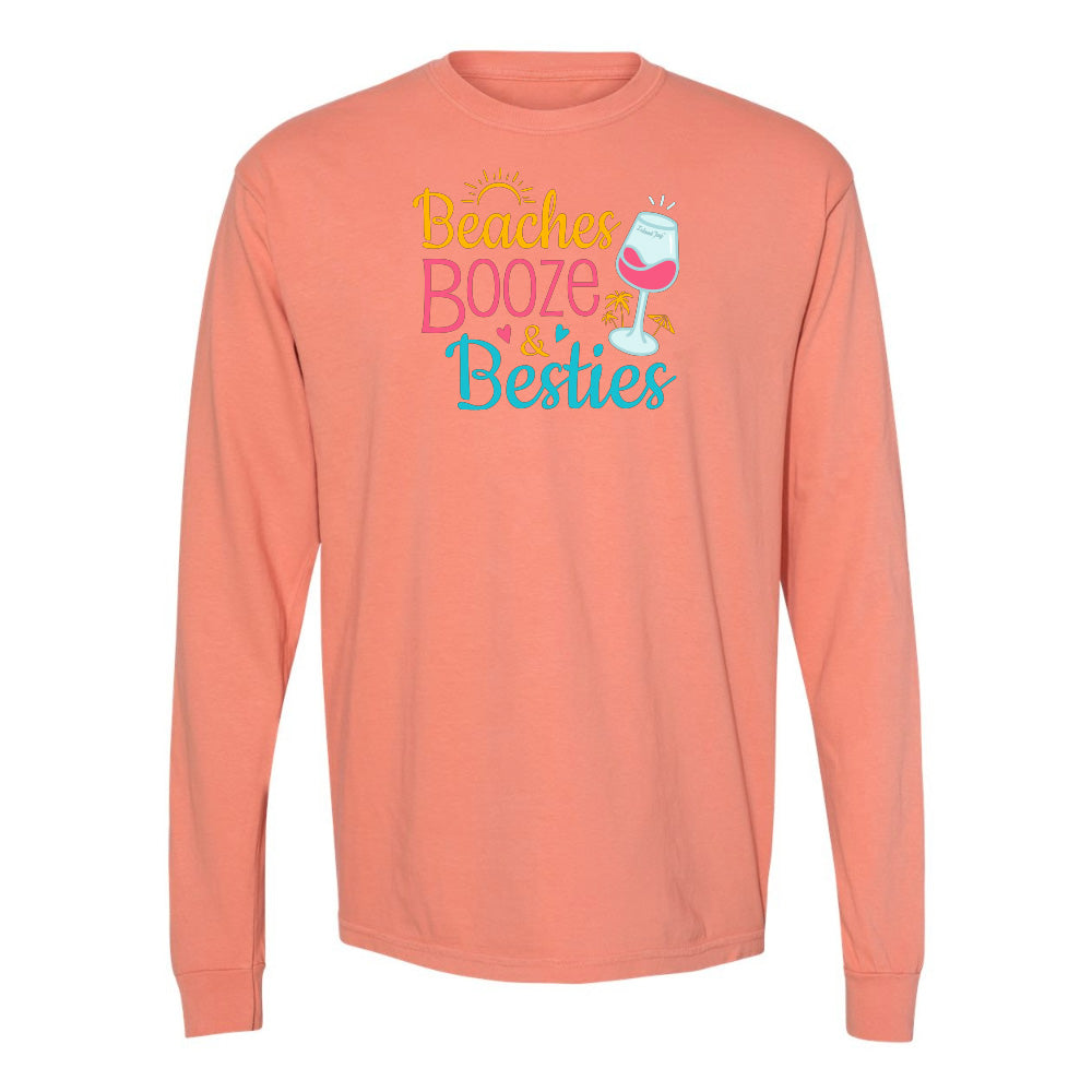 Coral long-sleeve shirt with 'Beaches, Booze & Besties' text and wine glass graphic on a white background