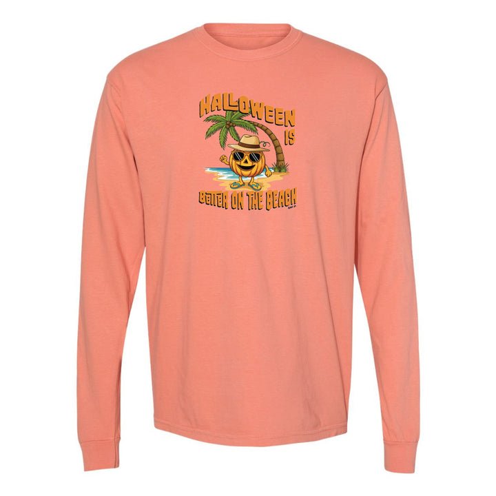 Peach long-sleeve shirt with Halloween design featuring a pumpkin on a beach.
