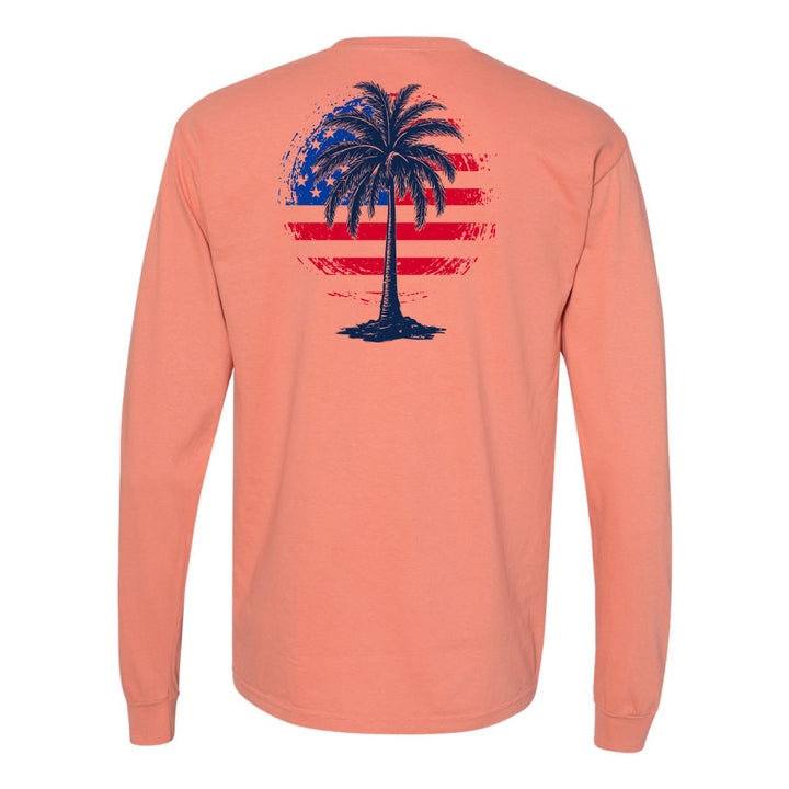 Peach long-sleeve shirt with a palm tree and American flag design on the back against a white background.