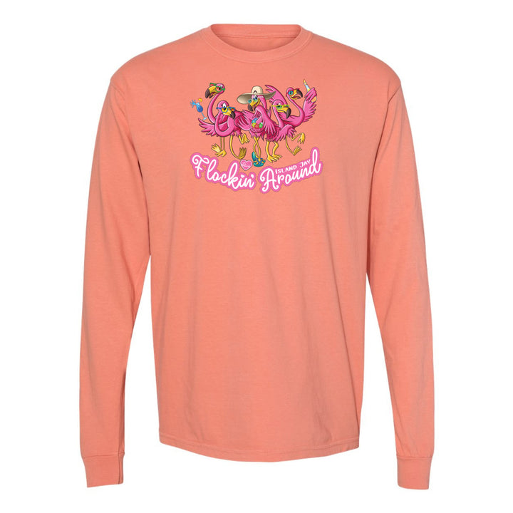 Coral long-sleeve shirt with flamingo design and text on a white background