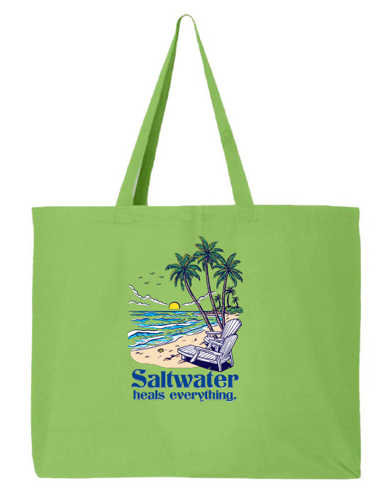 Green tote bag with a beach scene and 'Saltwater heals everything' text on a white background