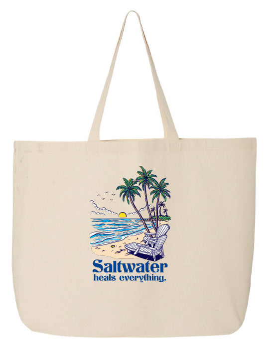 Beige tote bag with beach scene and 'Saltwater heals everything' text on a white background