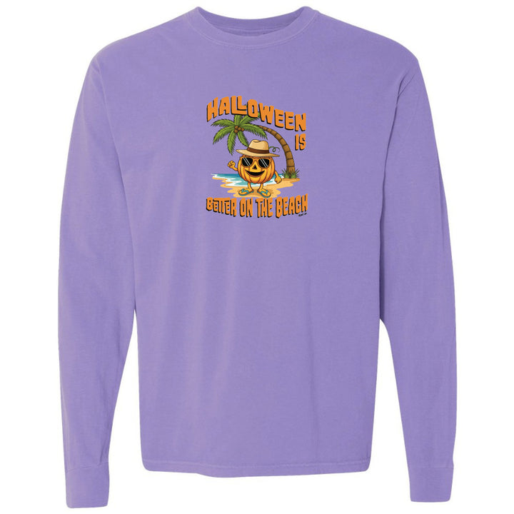 Purple long-sleeve shirt with a Halloween design featuring a pumpkin on a beach.