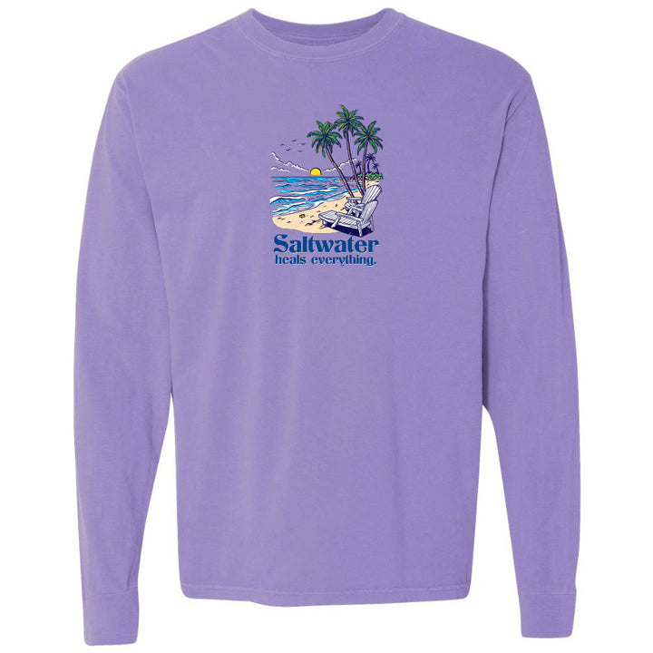 Purple long-sleeve shirt with a beach graphic and 'Saltwater heals everything' text on a white background