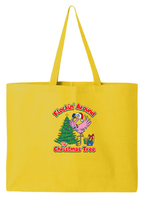Yellow tote bag with Christmas-themed design featuring a flamingo and tree on a white background